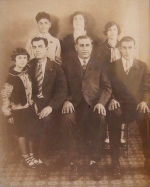 a family portrait (Pamela is young girl on far left, standing next to her father)