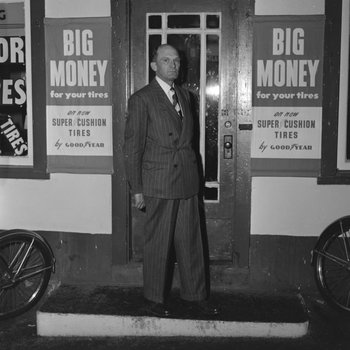Man in a suit standing in front of William's Store. Broadway, Va.