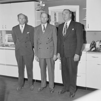Three men standing in front of a showcase of Hotpoint Appliances inside of William's Store. Broadway, Va.