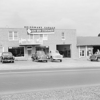 Heishman's Garage. Banner hangs on front of building advertising the "new 1950 Studebaker."