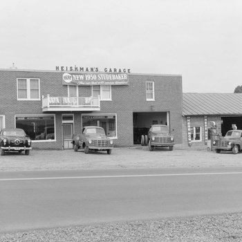 Heishman's Garage. Banner hangs on front of building advertising the "new 1950 Studebaker." 2