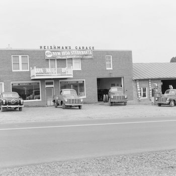 Heishman's Garage. Banner hangs on front of building advertising the "new 1950 Studebaker." 3