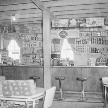 Basye Community Store. Inside view facing counter with bar stools and various candy and food products shown on the shelves.
