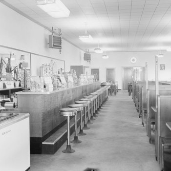 Inside of Walter's Restaurant, with both the counter and opposite booth tables pictured.