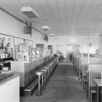 Inside of Walter's Restaurant, with both the counter and opposite booth tables pictured. 2