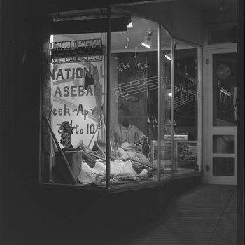 The front window of Hodgin's Store (electronics and sporting goods) in Woodstock, Va. Window advertises National Baseball Week, April 3-10. 5