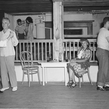 Inside of the Shenandoah Alum Springs Hotel, a group of people socializing and dancing. Orkney Springs, Va.