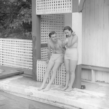 Man and woman standing on the side of the swimming pool at the Shenandoah Alum Springs Hotel. Orkney Springs, Va.