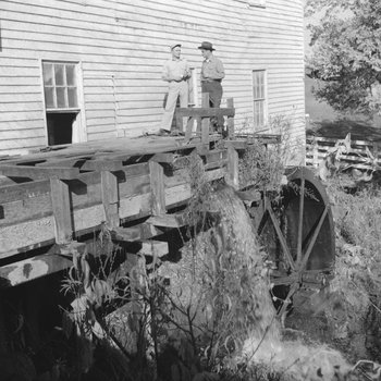 Bryce's Mountain Resort, close-up of two men standing on the water wheel. Basye, Va.