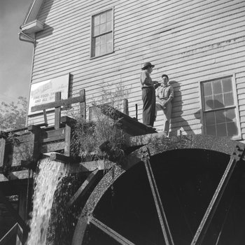 Bryce's Mountain Resort, view from the ground of two men standing on the water wheel. Basye, Va.