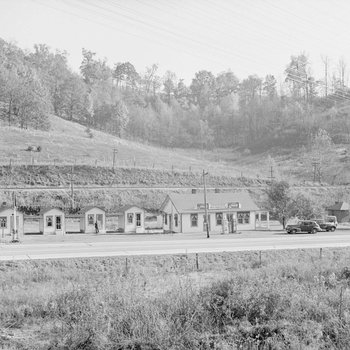 Ike's Tourist Camp, roadside cabins with a Texaco service station, distant front view. 2