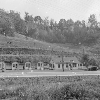 Ike's Tourist Camp, roadside cabins with a Texaco service station, distant front view. 3