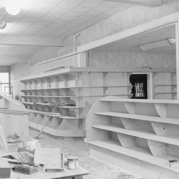Empty shelving inside of a store or building, alternate view.