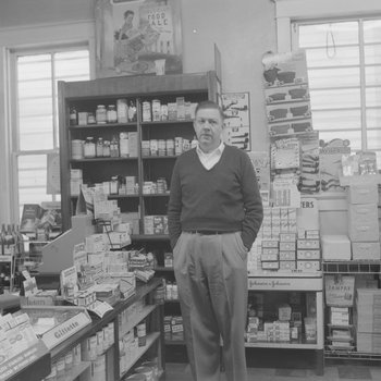 Alternate view of shelving inside of a store or building with a man pictured in a different location.