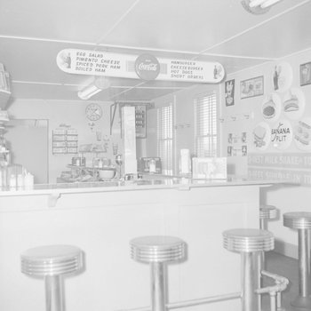 Inside of a diner, view of separate menu and counter.
