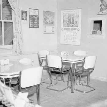 Inside of a diner or restaurant, view of two corner tables. 2