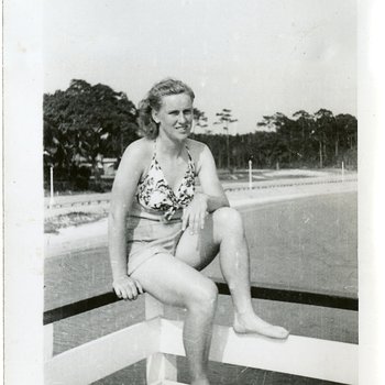 1946 circa - Jean Faut in a bathing suit sitting on a boat