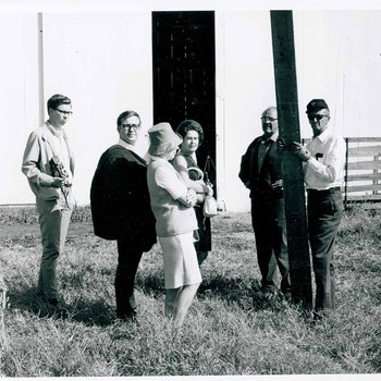 Unidentified people discussing the movie by a barn used for the filming of "The Learning Tree," on location in Bourbon and Linn counties, Kansas