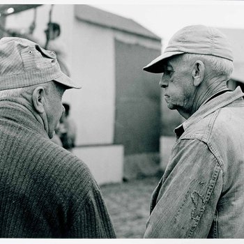 Two unidentified men by a barn used during the filming of "The Learning Tree," on location in Bourbon and Linn counties, Kansas