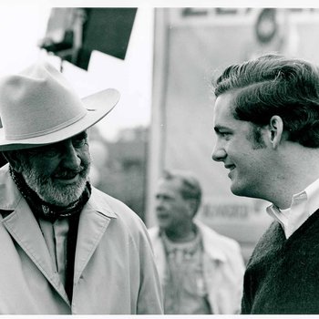 "The Learning Tree" cinematographer, Burnett Guffey chats with a young man on location in Bourbon and Linn counties, Kansas