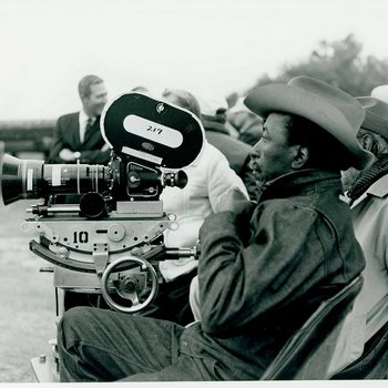 Gordon Parks sits behind a movie camera on location for "The Learning Tree" in Bourbon and Linn counties, Kansas 2