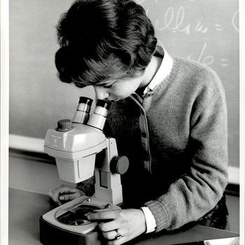 Student Looking Through the Microscope, Student Candids, ca. early 1960s