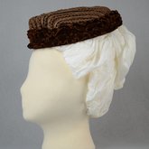 Toque, brown straw trimmed with brown velvet ruffles, c. 1870s, side view