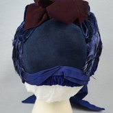 Bonnet, blue felt capote with blue velvet, blue feather trim, and velvet ribbon in blue and burgundy, 1880s, back view