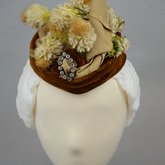 Toque, oval shape with cream ribbon, brown velvet, and artificial flowers, 1890s, front view