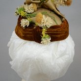 Toque, oval shape with cream ribbon, brown velvet, and artificial flowers, 1890s, back view
