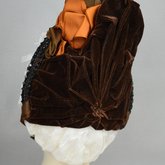 Bonnet, brown velvet capote with jet trim and teal, brown, and orange satin ribbons, 1880s, back view