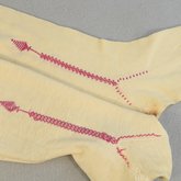 Stockings, cream cotton with red embroidered clocks, 1840s-1850s, back and front embroidery comparison