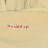 Stockings, white cotton with white embroidered clocks, 1865-1880, detail of label
