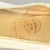 Shoes, white kidskin slippers with ribbon bow, 1860s-1870s, detail of label