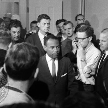 Crowd of news reporters gather as James Meredith exits classroom