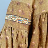 Housedress, brown printed cotton, c. 1835-1850, detail of yoke and sleeve piping, trim, gathers, and sleeve piecing