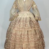 Dress, fan-front bodice and tiered skirt, of printed barege, 1850s, front view