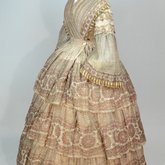 Dress, fan-front bodice and tiered skirt, of printed barege, 1850s, side view