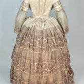 Dress, fan-front bodice and tiered skirt, of printed barege, 1850s, back view