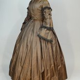 Dress, brown silk with black fringe trim, 1853-1863, side view