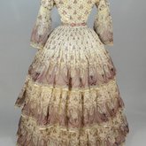 Dress, paisley-printed mull with fan-front bodice and tiered skirt, 1863, back view