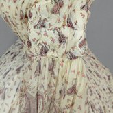 Dress, paisley-printed mull with fan-front bodice and tiered skirt, 1863, detail of sleeve puff