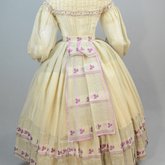 Walking dress, three pieces with bodice, skirt, and sash, beige barege with purple stripes and leaves, 1860s, back view