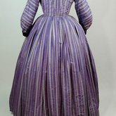 Dress, purple silk with silver, black, and pink stripes, c. 1865, back view