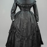 Dress, black plain weave silk with ruffles, c. 1870, front view