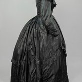 Dress, black plain weave silk with ruffles, c. 1870, side view