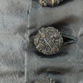 Dress, black plain weave silk with ruffles, c. 1870, detail of button
