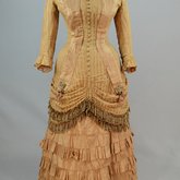 Dress, amber silk taffeta with chenille-fringed barege overdress, c. 1880, front view