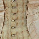 Dress, amber silk taffeta with chenille-fringed barege overdress, c. 1880, detail of overdress buttons and trim