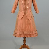 Girl’s dress, salmon and maroon silk taffeta check with bustle, 1880s, front view